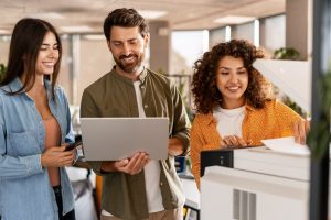 Employees reviewing office printer performance during a print assessment.